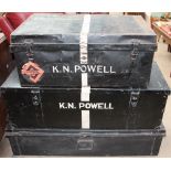 A black painted tin trunk together with two other tin trunks