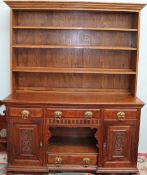 An Edwardian oak sideboard base with a later bookcase top,