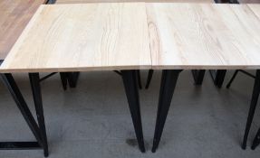 A set of seven ash topped cafe tables on tapering legs