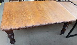 A 19th century extending oak dining table on fluted turned tapering legs includes additional leaves