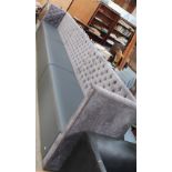 A button back upholstered bench seat in three sections