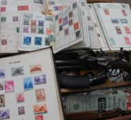 A stamp album containing world stamps together with other stamp albums, loose stamps,