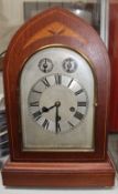 An early 20th century inlaid mahogany bracket clock with a silvered dial and Roman numerals with a