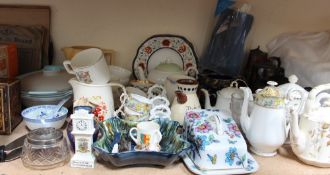 A Victorian pottery teapot and hot water jug together with assorted teapots and jugs,