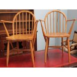 A pair of Ercol spindle back elbow chairs with Utility mark stamp and impressed F.