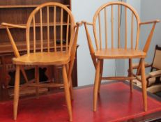 A pair of Ercol spindle back elbow chairs with Utility mark stamp and impressed F.