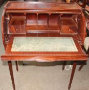 A reproduction mahogany cylinder bureau with a pull out writing surface, drawers and pigeon holes,