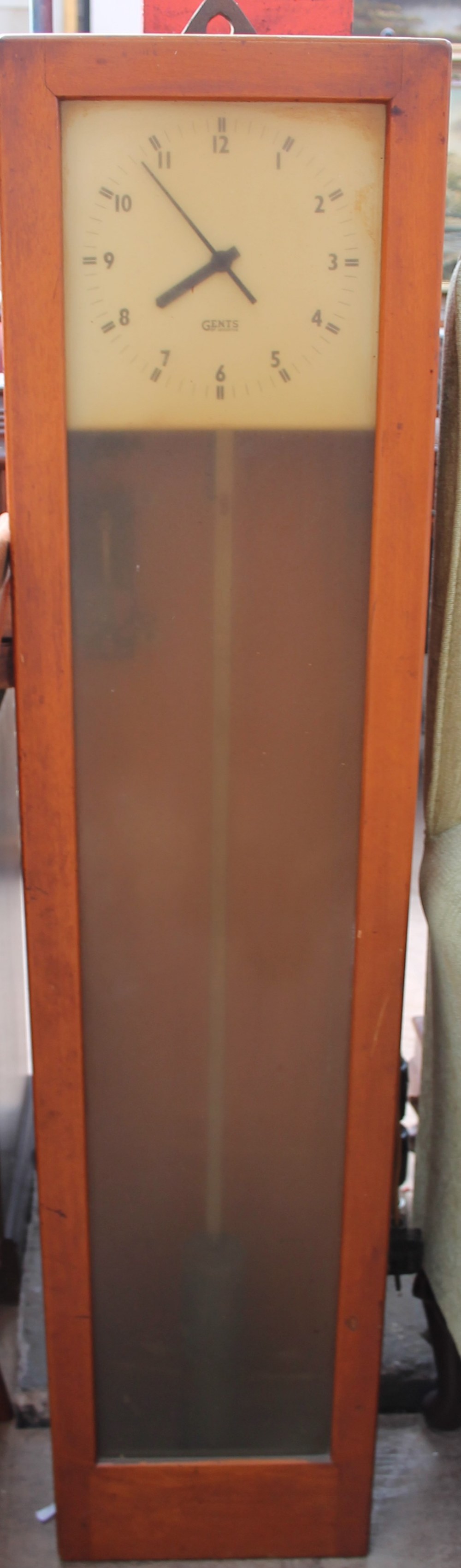 A Gents electric wall clock, with a glazed door,