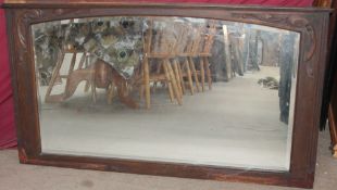 An Art Nouveau style oak wall mirror