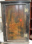A black lacquer chinoiserie decorated hanging corner cupboard