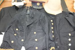 Assorted naval uniforms together with an HMS Goldcrest hat and other hats