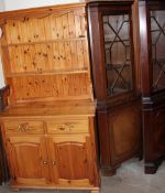 A pine kitchen dresser together with a pair of reproduction standing corner cupboards and a wall