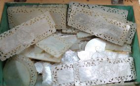 A collection of mother of pearl counters engraved with figures and trees etc