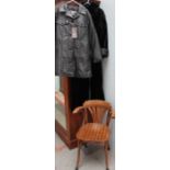 A bent wood chair together with a faux fur coat and another coat