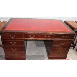 A reproduction mahogany pedestal desk with a leather inset top on plinths