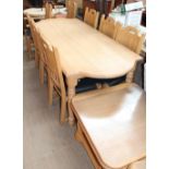 An oak dining suite comprising a dining table, eight chairs, wall unit, bookcase,