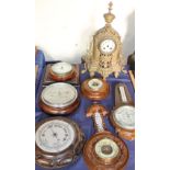 A bronze mantle clock together with aneroid barometers etc