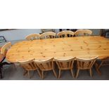 A modern pine dining table together with a set of ten dining chairs and cover