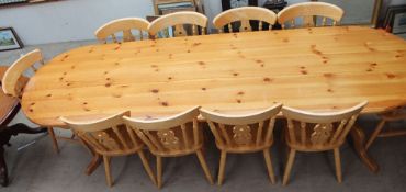 A modern pine dining table together with a set of ten dining chairs and cover