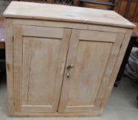 A pine linen press top with a pair of cupboard doors