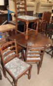 A 20th century oak gate leg dining table together with four ladder back dining chairs