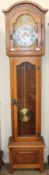 A 20th century oak long case clock with a silvered dial and Roman numerals