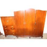 A 20th century mahogany triple wardrobe together with a matching dressing table and a tallboy