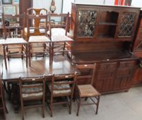 A 20th century oak extending dining table, dresser and four ladder back dining chairs,