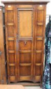 A 20th century oak wardrobe with a panelled door