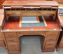 A late Victorian Edwardian mahogany desk with a serpentine fronted tambour front,
