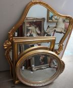 A large gilt wall mirror together with three other gilt wall mirrors