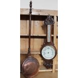 A oak cased aneroid barometer with a mercury thermometer together with a copper bed warming pan