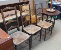 A set of three oak ladder back bedroom chairs together with an elbow chair,