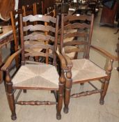 A set of eight 20th century oak ladder back dining chairs, with rush seats,