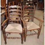 A set of eight 20th century oak ladder back dining chairs, with rush seats,