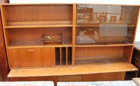 A teak wall unit and a table top bookcase