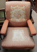 A Victorian rosewood nursing chair with tapestry upholstery on barley twist legs and arm supports