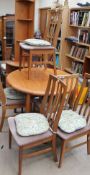 A teak dining table together with six chairs and a corner cupboard