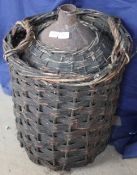 A wicker work basket containing a metal casket