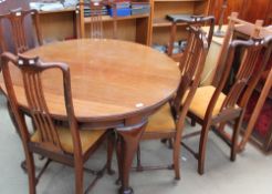 A 19th century mahogany dining table of oval form with three leaves on cabriole legs together with