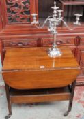 A 20th century mahogany tea trolley together with an electroplated four branch candelabra