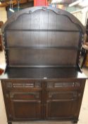 A 20th century oak Dutch dresser together with a set of six oak dining chairs with a bergere back