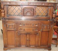 A 20th century oak court cupboard with a glazed top
