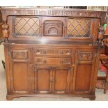 A 20th century oak court cupboard with a glazed top