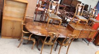 A reproduction walnut extending dining table,