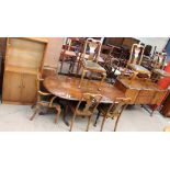 A reproduction walnut extending dining table,