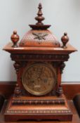 A walnut mantle clock, with a domed top,