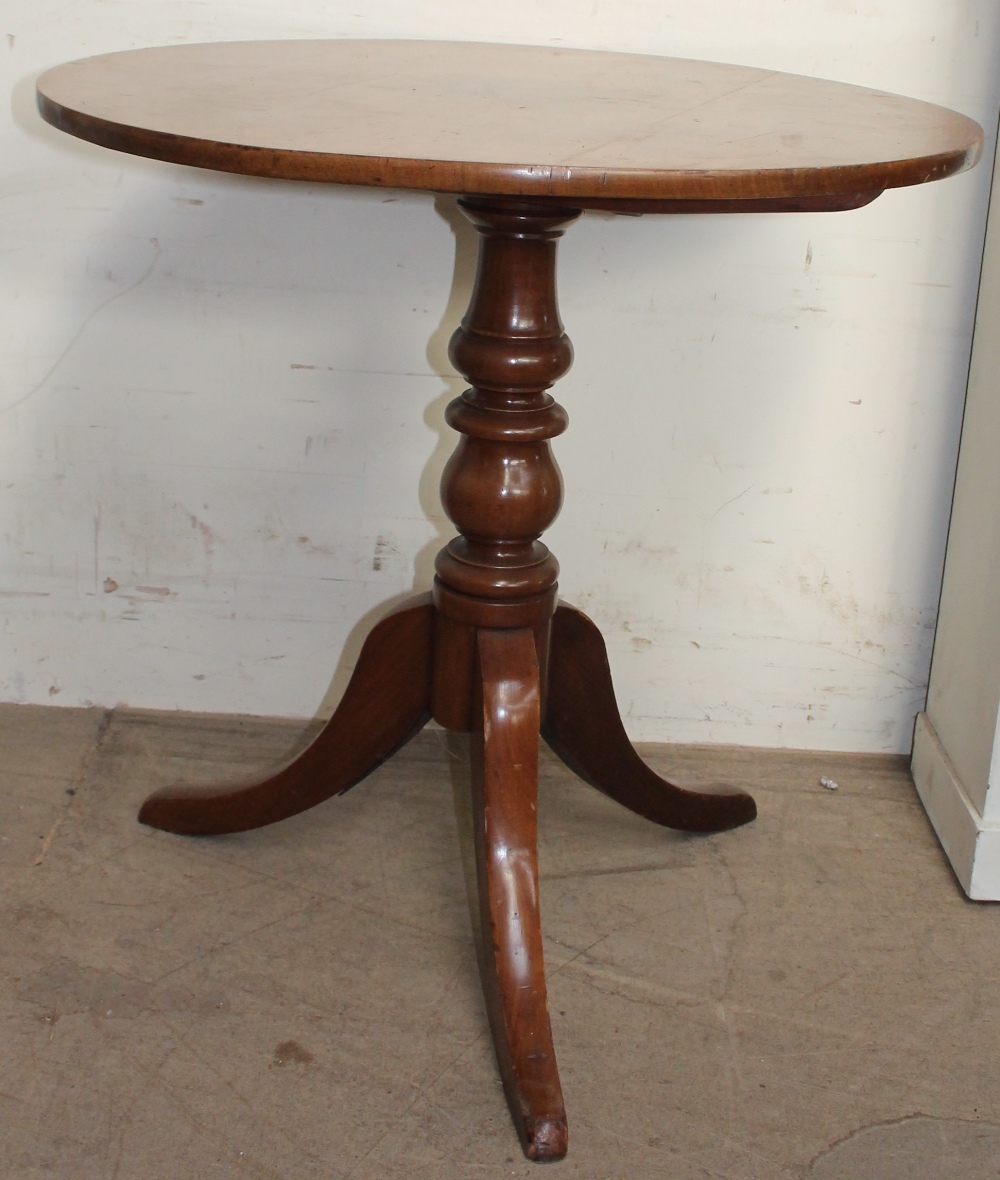 A Victorian mahogany tripod table with a turned column and spreading legs
