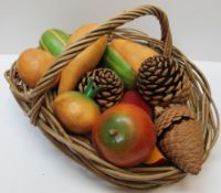 A basket of wooden fruit and pine cones