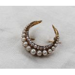 A diamond and pearl crescent brooch,